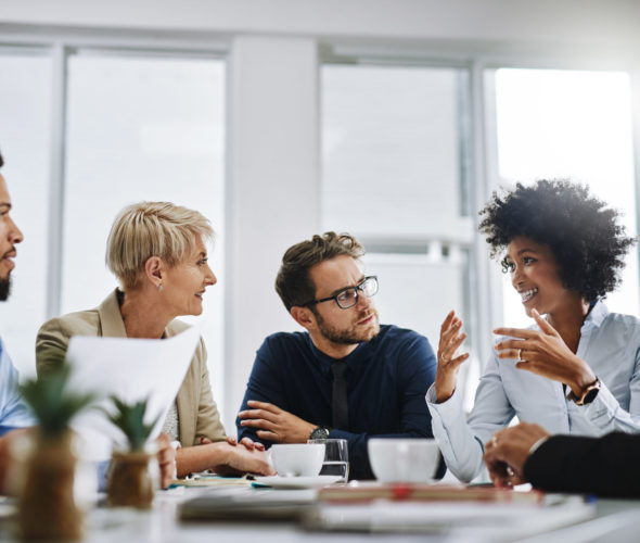 Shot of a group of businesspeople sitting together in a meeting